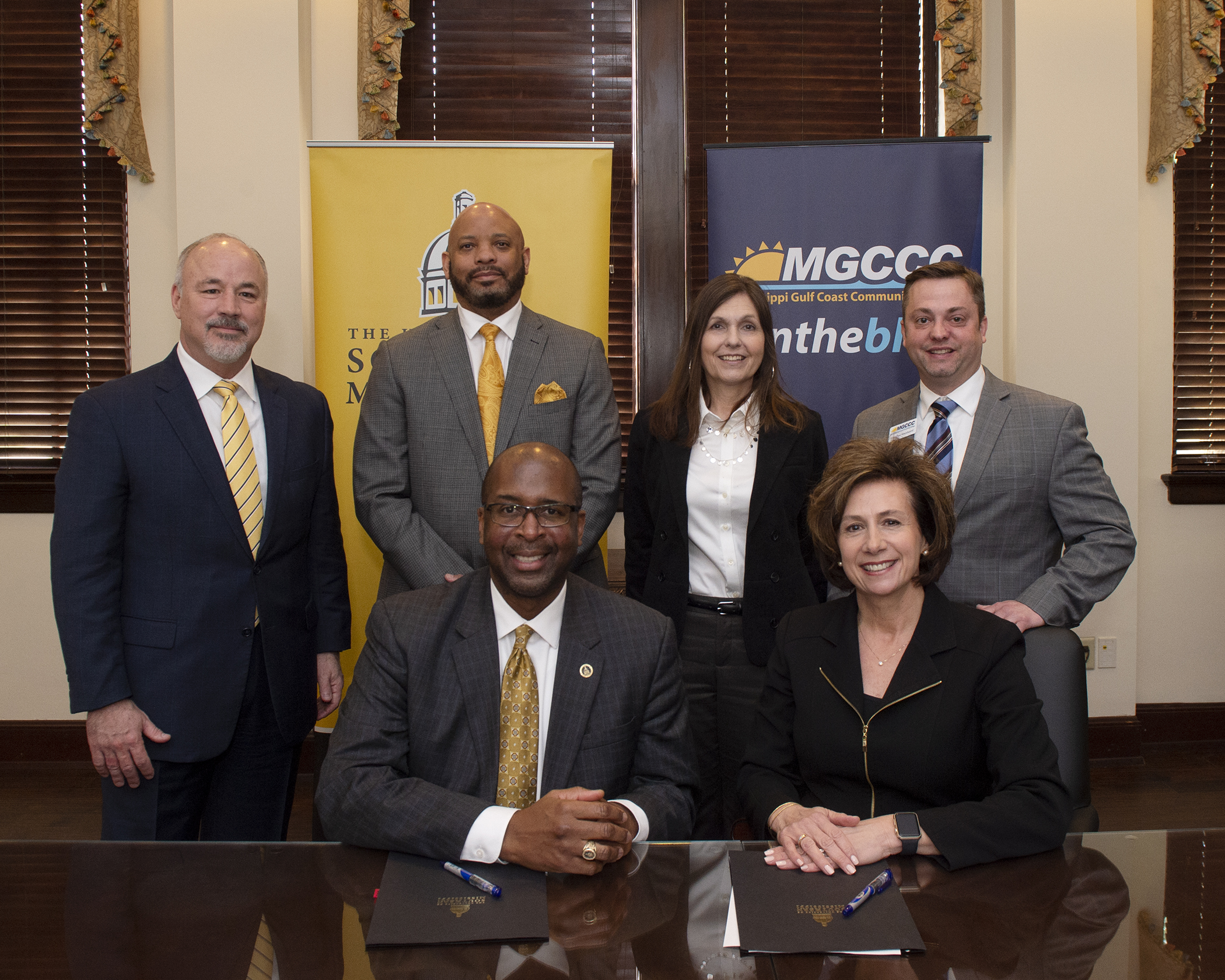 ) Seated are Dr. Rodney D. Bennett, USM president, and Dr. Mary S. Graham, MGCCC president. Standing, from left, are Dr. Steven R. Moser, provost and senior vice president for Academic Affairs at USM; Dr. Alfred Rankins Jr., Mississippi Institutions of Higher Learning Commissioner Of Higher Education; Dr. Andrea Mayfield, executive director of the Mississippi Community College Board; and Dr. Jonathan Woodward, MGCCC executive vice president, Teaching & Learning/Community Campus.