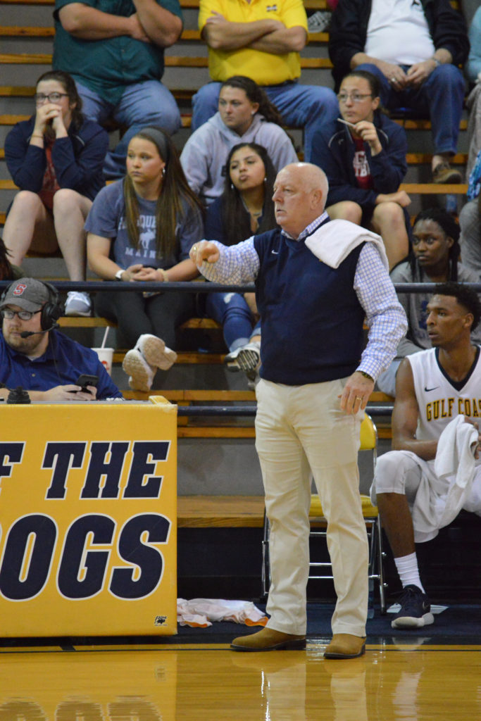 Coach Wendell Weathers on the sidelines at a basketball game.