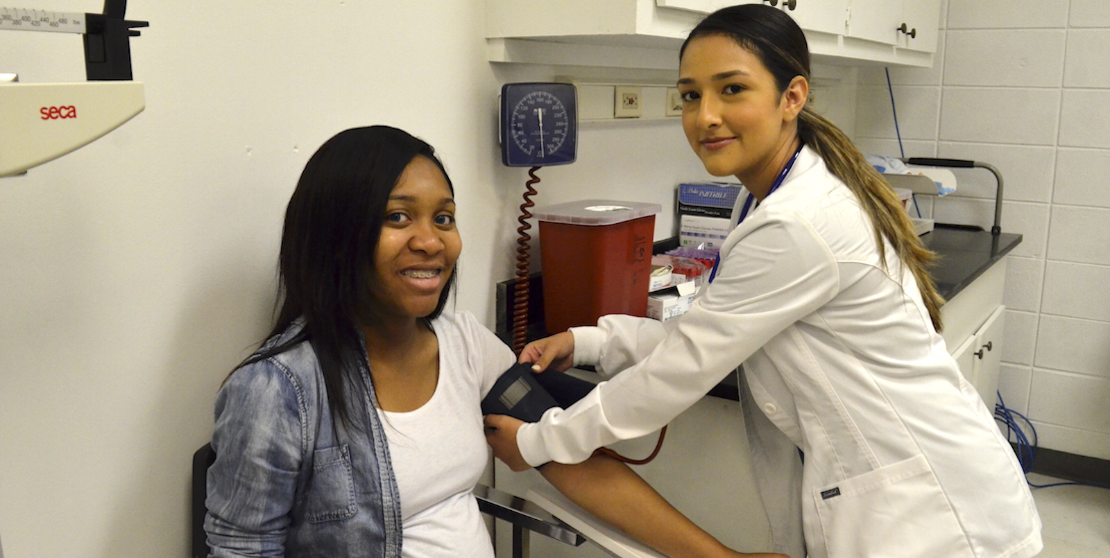 medical assistant checking blood pressure