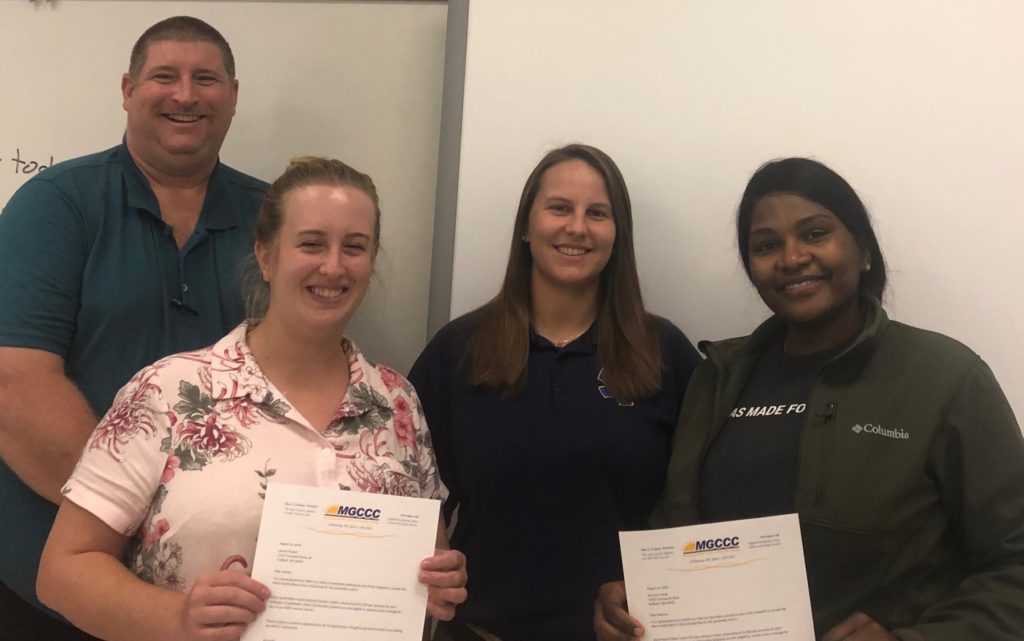 MGCCC Emergency Medical Services students Shanna Cramer and Lauren Powell were awarded the 2019 Merit Health – Biloxi Board of Trustees Full-Tuition Scholarship.  From left are Dr. Ron Morgan, Emergency Medical Sciences (EMS) program director; Lauren Powell; Hillary White, EMS Clinical coordinator; and Shanna Cramer.