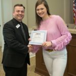Dr. Jonathan Woodward, executive vice president of Teaching & Learning/Community Campus and QEP Chair, presents a certificate to MGCCC student Morgan Rich at a meeting of the QEP Implementation Committee.