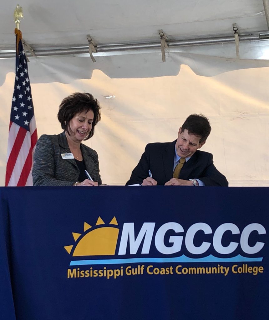 Dr. Mary S. Graham, MGCCC president, and Ron Baczkowski, VT Halter Marine president and CEO sign paperwork to create a shipbuilder apprenticeship program.