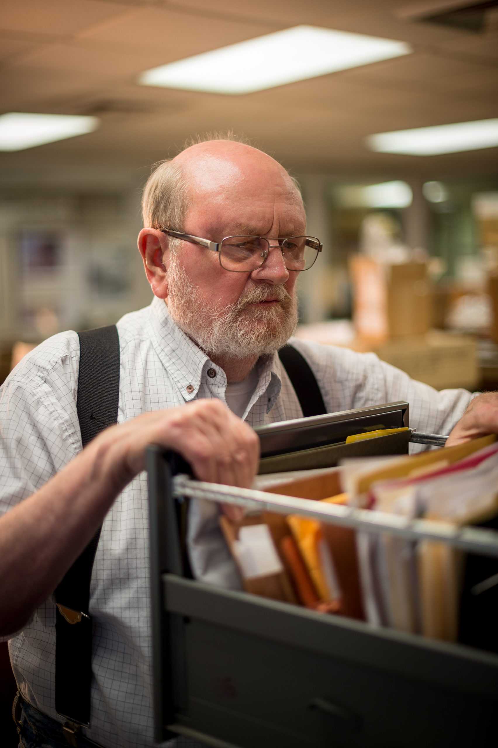 MGCCC archivest Charlie Sullivan looking through files in the archive collection