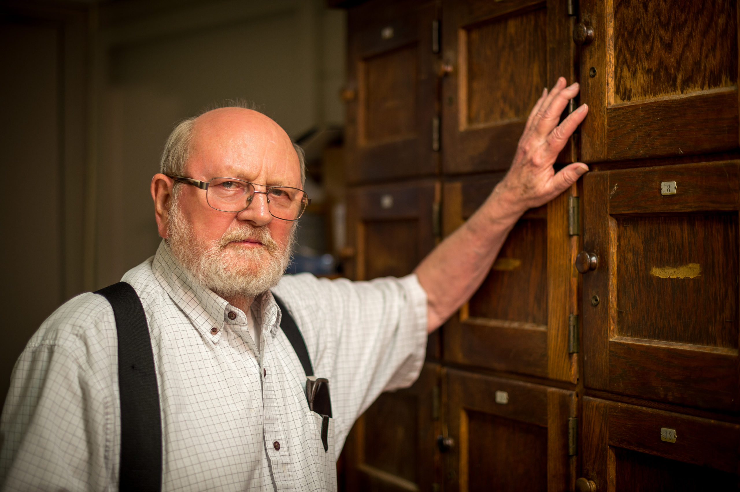 MGCCC archivest Charlie Sullivan in front of file cabinets in the archives collection
