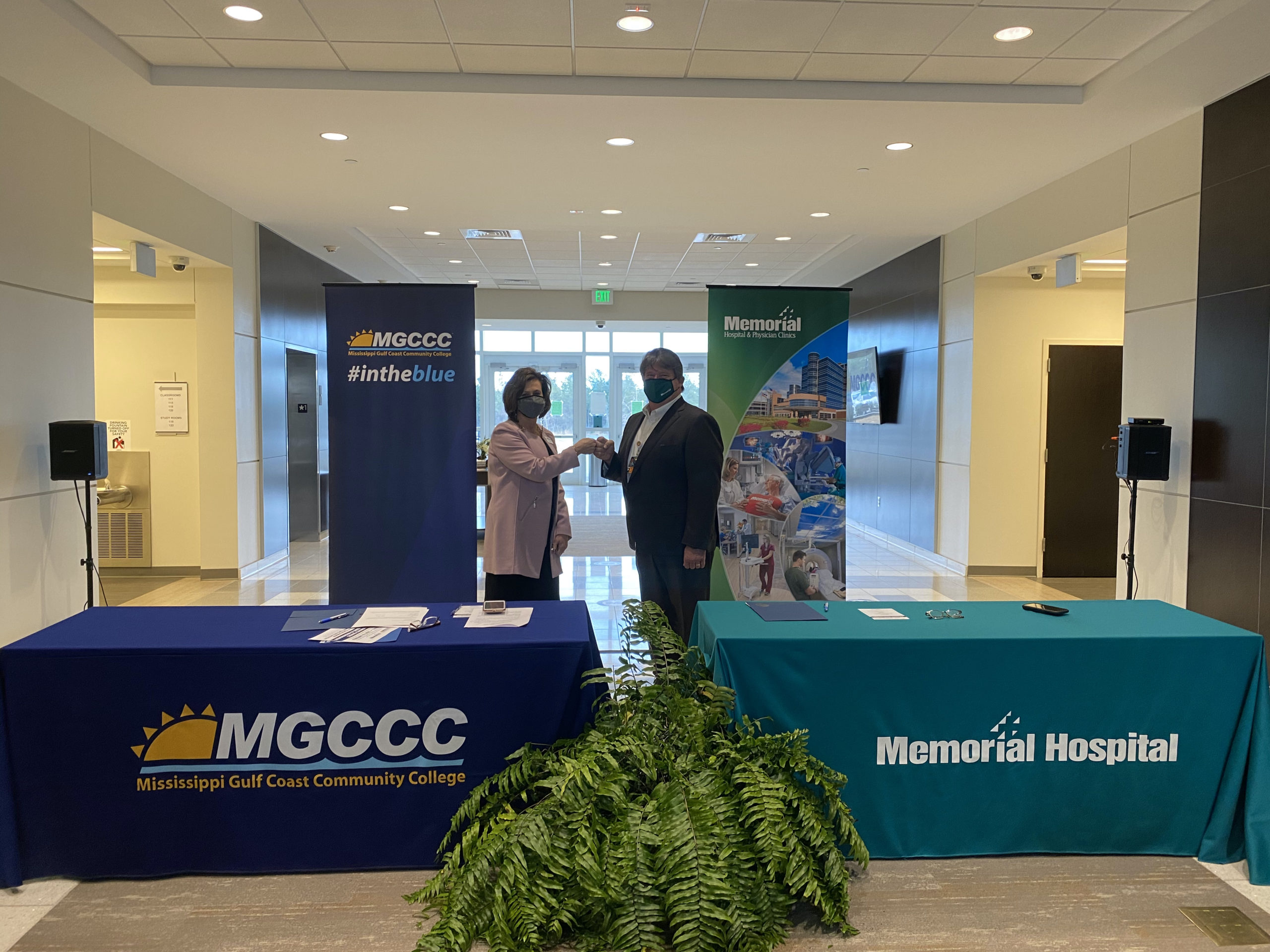 Fist bump between MGCCC President Dr. Mary S. Graham and Kent Nicaud, president/CEO of Memorial Hospital at Gulfport, after the MOU signing at MGCCC’s Bryant Center on February 10. 