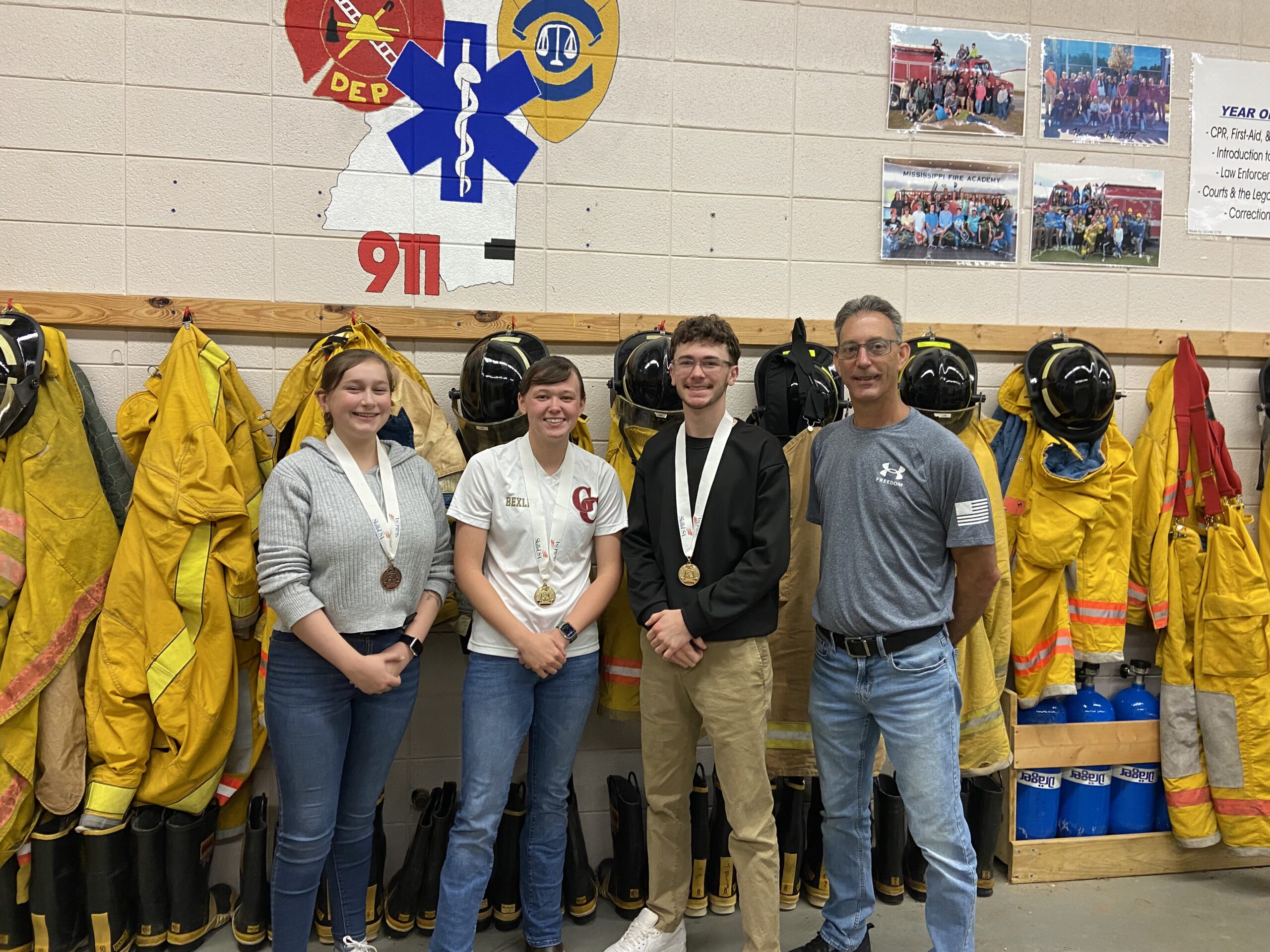 )  Secondary Winners From left are Amy Smith, third place, CPR; Rayne Bexley, first place, EMT; Bishop Ladnier, first place, EMT; and John Glass, EMT instructor.