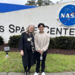 Antoine Nguyen with MGCCC instructor Allison Mull in front of the sign at Stennis Space Center.