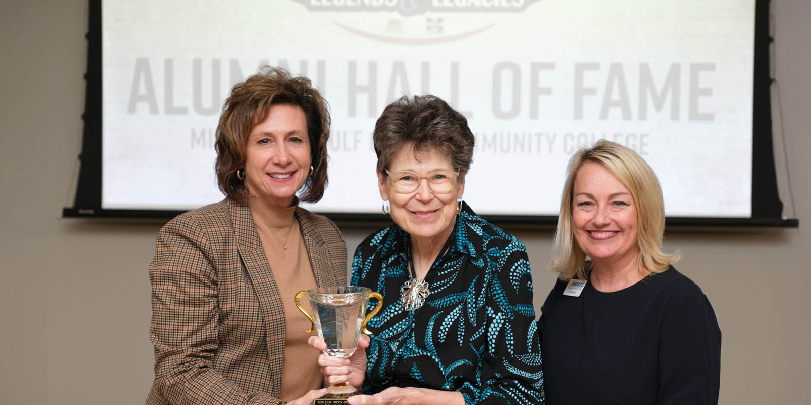 Dr. Graham and Dr. Brown present Sam Owen Award to Patricia L. Holloway.