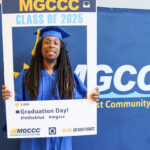 Arthur Minor at Adult Education Graduation in May 2025 standing in a large photo frame smiling.