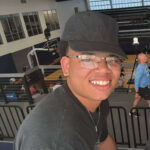 Tavon Reed portrait of him sitting at the Dantzler Center watching basketball.