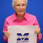 Edith Patton Rutherford at Jackson Hall holding up a piece of her cross stitch.