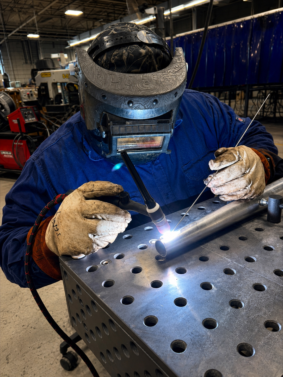 ) Leoundus “Leo” M. Garrett is welding the thorns into their proper shape.