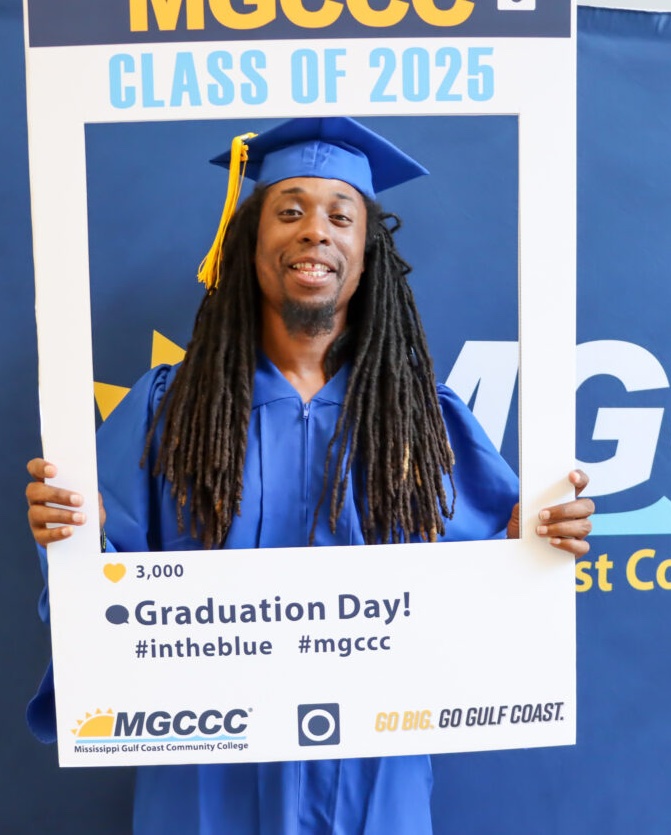 Arthur Minor with photo frame at adult education graduation